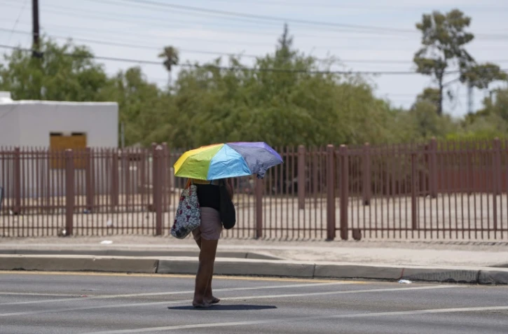 Une femme s'abrite du soleil lors d'une vague de chaleur à Tucson, dans l'Arizona (sud-ouest des Etats-Unis), le 15 juillet 2023