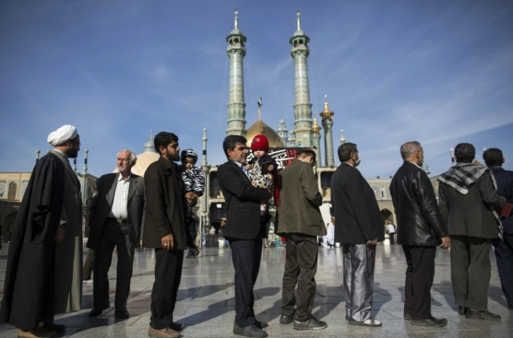 Les Iraniens patientent dans la file d'attente le 26 février 2016 à Qom, à 130 km au sud de Téhéran, pour choisir leurs députés