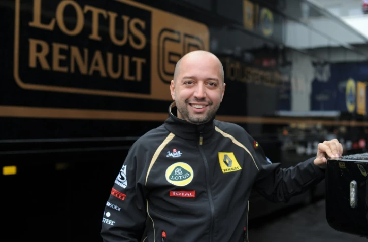 Le Luxembourgeois Gérard Lopez, alors propriétaire de Lotus Renault pose devant le stand de l'écurie au Nürburgring lors du GP d'Allemagne, le 24 juillet 2011