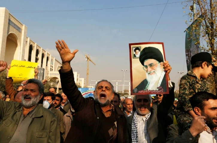 Des manifestants arborent un portrait du numéro un iranien Ali Khamenei lors d'un rassemblemen pororégime à Téhéran, le 5 janvier 2018