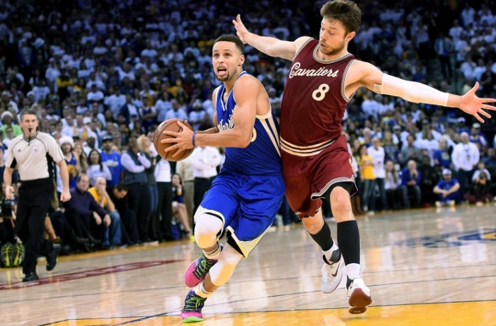 Stephen Curry (g) des Golden State Warriors face à Matthew Dellavedova des Cleveland Cavaliers lors du match de NBA à Oakland aux Etats-Unis, le 25 décembre 2015
