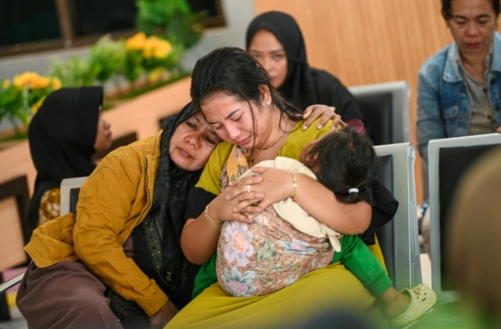 Des proches attendent des nouvelles de l'opération de recherche après le naufrage d'un ferry au large de l'île indonésienne de Bali, qui a fait plusieurs dizaines de disparus, à Banyuwangi, dans l'est de Java, le 3 juillet 2025