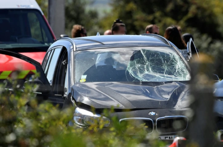 Des policiers autour d'une BMW endommagée avec un pare-brise cassé, après l'arrestation d'un suspect sur l'autoroute A16, près de la marquise, dans le nord, le 9 août 2017