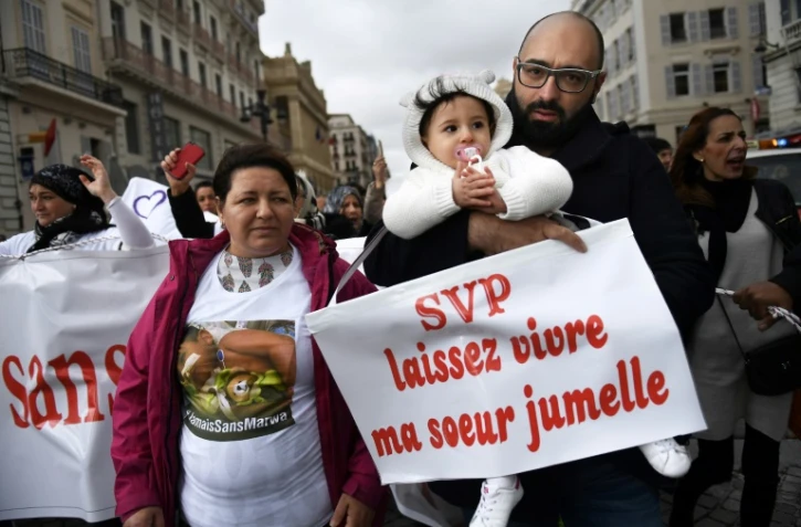 Sacha, 15 mois, dans les bras de son père Mohamed Bouchenafa, lors d'une manifestation pour Marwa, sa soeur jumelle, le 4 mars 2017 à Marseille