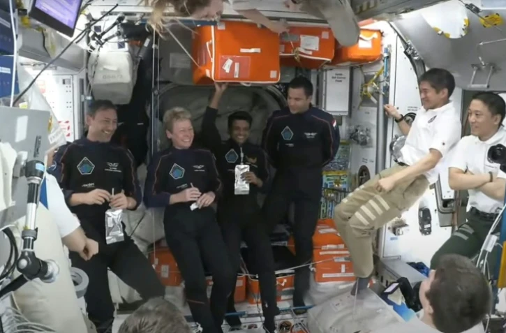 Image tirée d'une diffusion de NASA+, le 26 juin 2025, montrant l'équipage de la mission Axiom 4 à l'intérieur du module Harmony de la Station spatiale internationale (ISS) peu après l'amarrage du vaisseau spatial SpaceX Dragon Crew