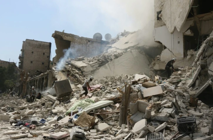 Des Syriens sont à la recherche de survivants dans les décombres après un raid à Alep, le 27 août 2016