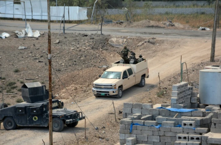 L'armée irakienne prend position dans le centre-ville de Qayyarah, dans le nord de l'Irak, le 24 août 2016