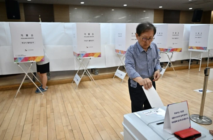 Un électeur dépose son bulletin lors de l'élection présidentielle sud-coréenne du 3 juin 2025, à Séoul