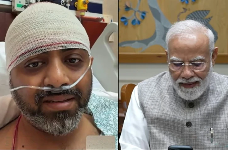 Capture d'écran, tirée d'une vidéo publiée le 2 octobre 2026 sur la chaîne YouTube de Narendra Modi, montrant le Premier ministre indien Narendra Modi (à droite) en train de s'entretenir par appel vidéo avec Smit Machchhar, pilote de la compagnie flydubai en convalescence dans un hôpital aux Émirats arabes unis