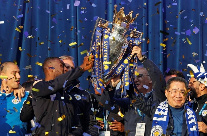 Le président de Leicester, le Thaïlandais Vichai Srivaddhanaprabha (d) et l'ex-entraîneur italien du club anglais, Claudio Ranieri (2e d), auprès du trophée de la Premier league, à Leicester, le 16 mai 2016