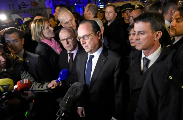 L'ancien président François Hollande (c), entouré de l'ancien ministre de l'Intérieur Bernard Cazeneuve (g) et de l'ex- premier ministre Manuel Valls (d), près du Bataclan, à Paris le 14 novembre 2015 