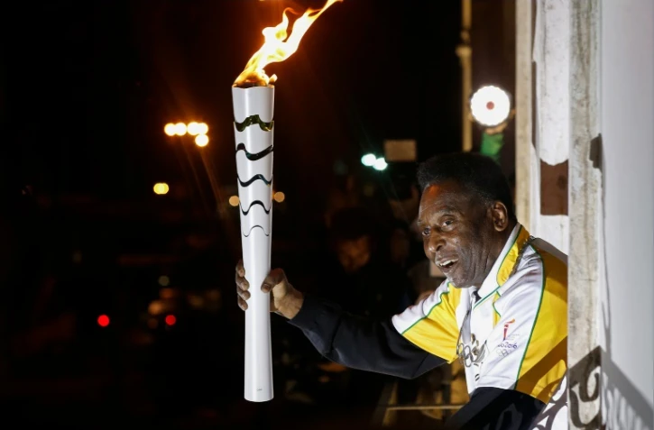 Le "Roi" Pelé exhibe la flamme olympique depuis le musée qui porte son nom à Santos, le 22 juillet 2016