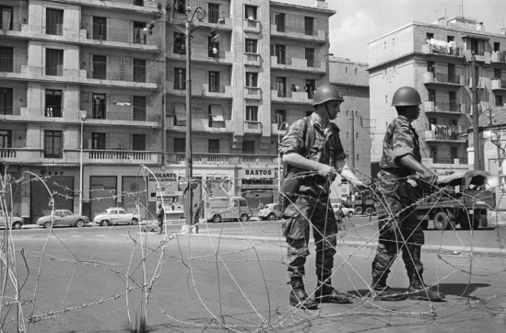 Des soldats ont procédé au bouclage du quartier européen d'Alger du "Champ de manoeuvres" et montent la garde devant les barbelés posés pour isoler le quartier le 04 mai 1962, après la signature des accords d'Evian