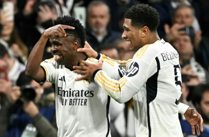L'attaquant du Real Vinicius Jr (g) buteur sur une passe de Jude Bellingham contre le RB Leipzig en 8e de finale retour de Ligue des champions, le 6 mars 2024 Ă Madrid