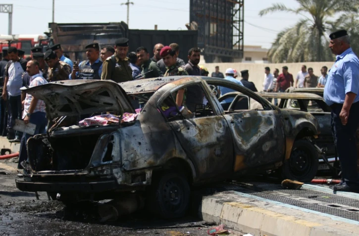 Une voiture calcinée après une attaque suicide, le 4 avril 2016 à Bassora en Irak