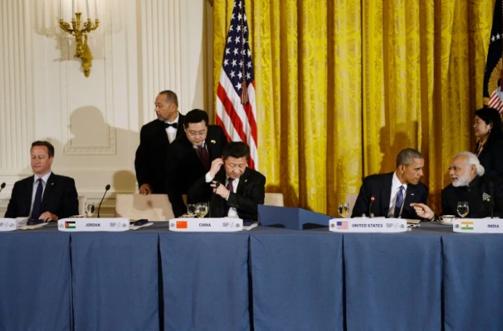 Le Premier ministre britannique David Cameron, le président chinois Xi Jinping, le président américain Barack Obama et le Premier ministre indien Narendra Modi lors d'un dîner de travail à la Maison Blanche à Washington, le 31 mars 2016