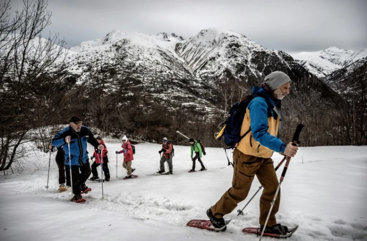 Des randonneurs en raquettes suivent leur guide de moyenne montagne dans la station des Deux-Alpes (Isère), le 4 février 2021
