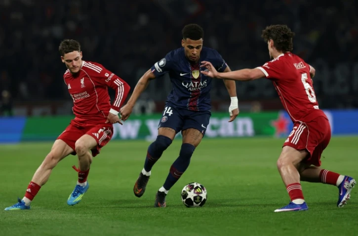 Florian Wirtz (G) de Liverpool voit filer Désiré Doué (C) du Paris SG lors de la victoire 2 à 0 des Parisiens, en quart de finale aller de Ligue des champions, le 8 avril 2026 au Parc des Princes