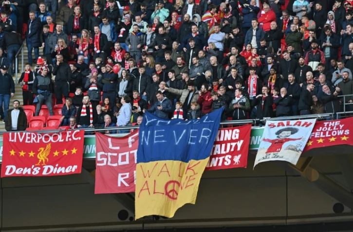 Une banderole reprenant l'hymne et la devise de Liverpool "You will never walk alone" est déployée aux couleurs de l'Ukraine, victime d'une invasion par la Russie, avant la finale de la Coupe de la Ligue entre Chelsea et Liverpool, le 27 février 2022 au Stade de Wembley à Londres