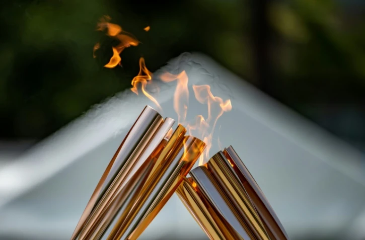 Passage de relais de la flamme olympique à Tokyo le 20 juillet 2021