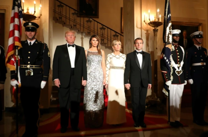le président Donald Trump et son épouse Melania Trump se tiennent à côté du président Emmanuel Macron et son épouse Brigitte Macron avant le diner à la Maison Blanche à Washington, DC, le 24 avril 2018