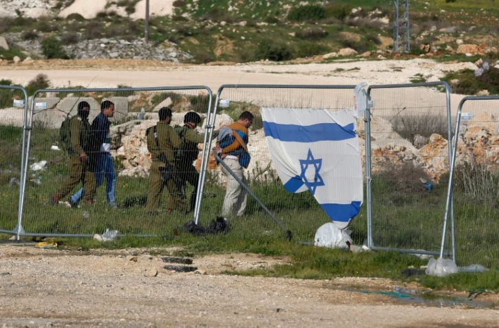 Les forces de sécurité israéliennes détiennent des Palestiniens après une attaque au couteau à Goush Etzion, sur le grand axe qui traverse la Cisjordanie du nord au sud et relie Jérusalem à Hébron, le 18 mars 2016 
