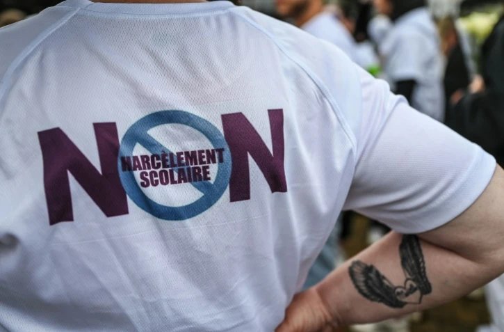 Un manifestant porte un T-shirt "Non au harcèlement scolaire" pendant une marche blanche dédiée à Lindsay, jeune fille de 13 ans qui s'est suicidée après avoir été harcelée, à  Vendin-le-Vieil (Pas-de-Calais) le 18 juin 2023