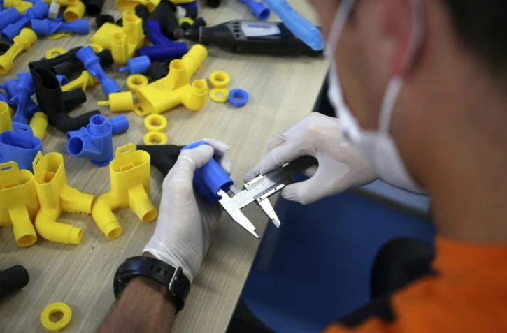 Des valves imprimées en 3D pour s'adapter à un masque de plongée qui sera transformé en respirateur, le 10 avril 2020 à Ajaccio, en Corse