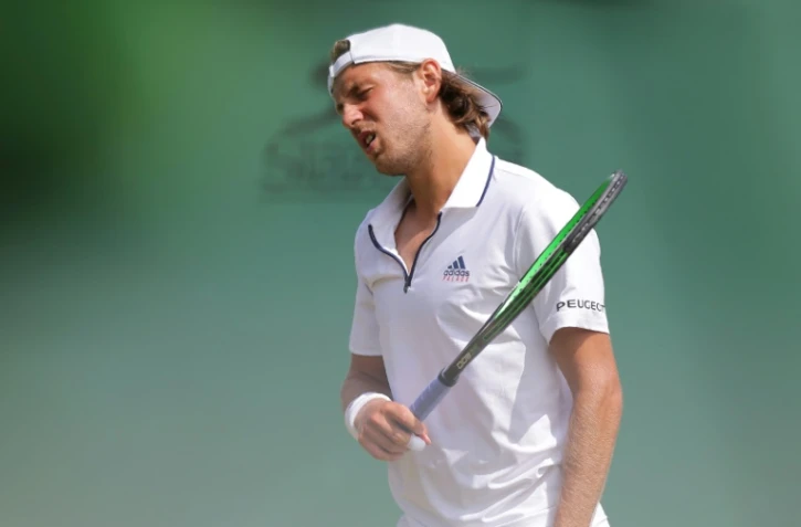 Le N.1 français Lucas Pouille face au 171e mondial, l'Autrichien Dennis Novak, lors du 2e tour à Wimbledon, le 4 juillet 2018
