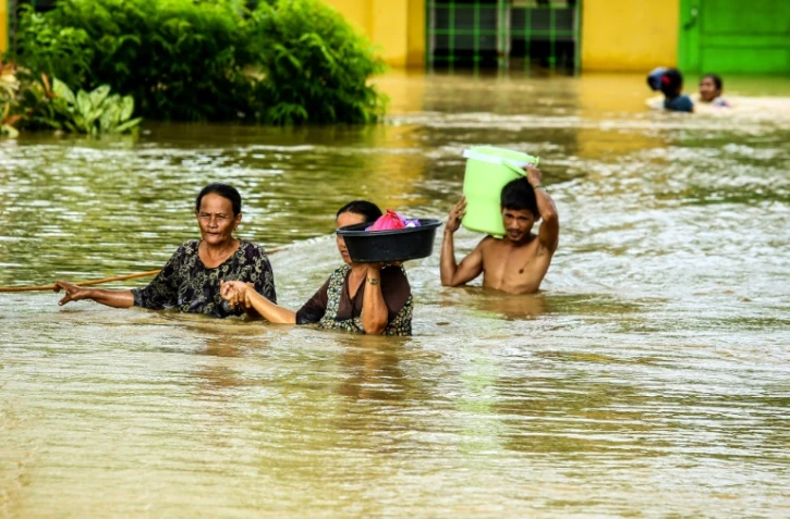 Des Philippins évacuent leurs habitations après le passage d'une tempête tropicale à Kabacan, dans le sud de l'île de Mindanao, le 23 décembre  2017