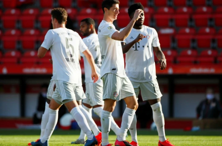 Robert Lewandowski, bras levé, célèbre avec ses équipiers le premier but du Bayern Munich sur la pelouse de l'Union Berlin le 17 mai 2020 en Bundesliga