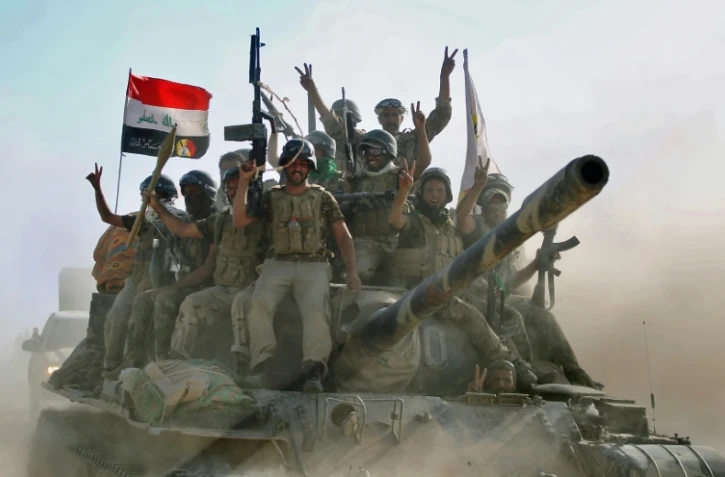 Des combattants irakiens du Hachd al-Chaabi, unités paramilitaires avancent dans Tal Afar, l'un des derniers bastions de l'Etat islamique en Irak, le 22 août 2017