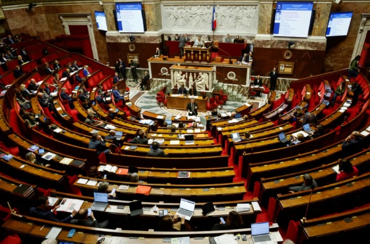 Le ministre de l'Intérieur Gérald Darmanin (c) lors des débats sur le projet de loi immigration à l'Assemblée nationale, le 7 décembre 2023 à Paris