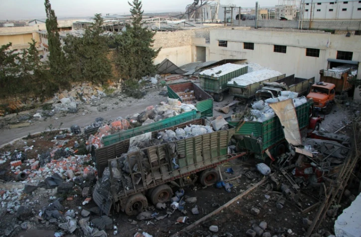 De l'aide humanitaire éparpillée à terre à Orum al-Kubra près d'Alep, le 20 septembre 2016 au lendemain du raid aérien meurtrier contre un convoi humanitaire