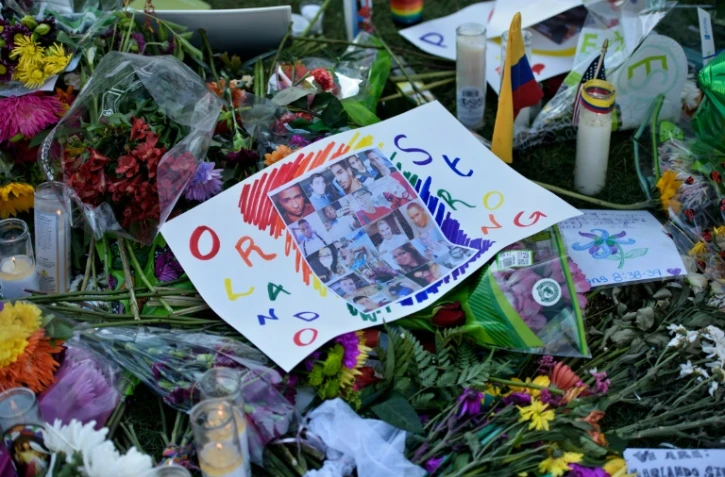 Des photos et des fleurs déposées en hommage aux victimes de la tuerie d'Orlando, à Orlando en Floride, le 14 juin 2016