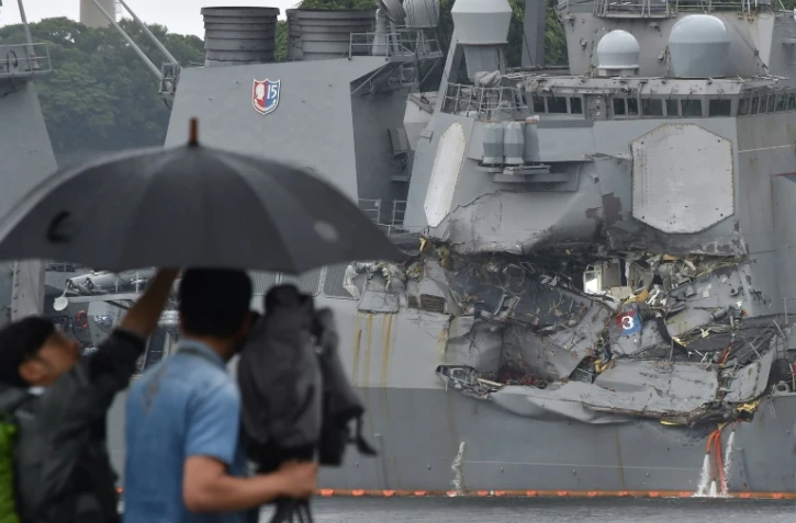 Un caméraman filme dans le port de Tokyo le 18 mai 2017 un destroyer américain entré en collision avec un cargo