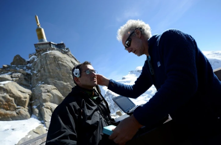 Emmanuel Cauchy (à droite) ausculte un alpiniste en avril 2013 au sommet de l'Aiguille du Midi