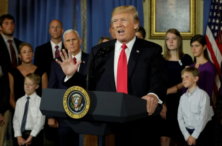 Le président américain Donald Trump s'exprime sur la réforme de la santé entouré de présumées "victimes d'Obamacare", à la Maison Blanche à Washington le 24 juillet 2017