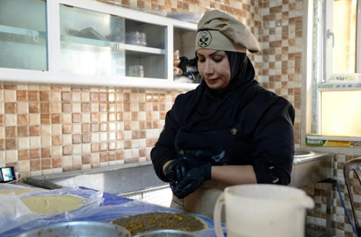 Abir Jassem prépare des plats dans la cuisine de l'entreprise "Le Goût de Mossoul", gérée par des femmes, le 13 septembre 2023 à Mossoul, en Irak