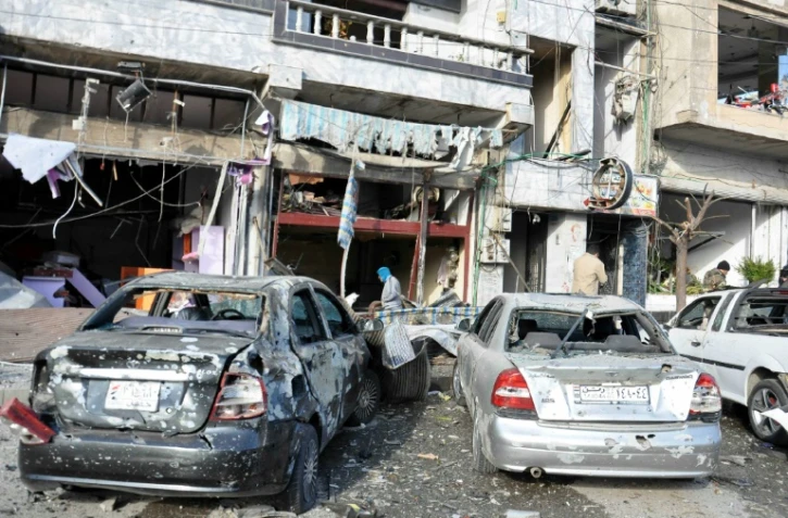 Photo remise par l'agence de presse officielle syrienne, Sana, montrant les suites d'un double attentat suicide à Homs, le 26 janvier 2016