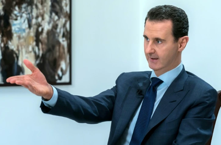 Photo transmise par l'agence officielle syrienne Sana du président Bachar al-Assad lors d'une interview, le 10 juin 2018 à Damas
