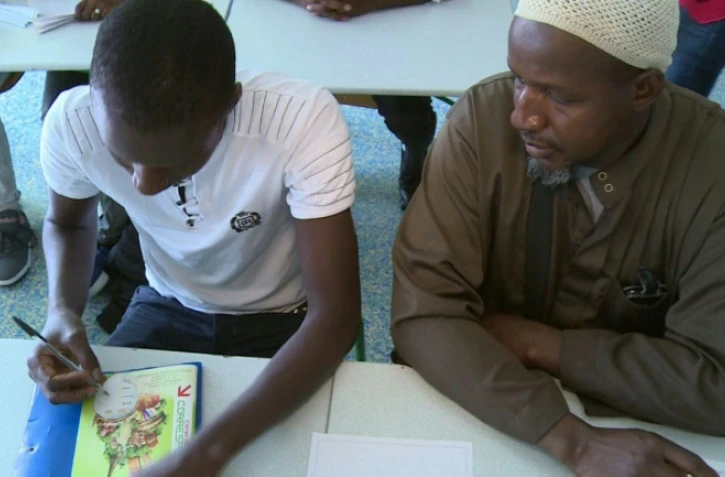 Mamedy, 15 ans, fraîchement arrivé du Mali, fait sa rentrée scolaire au côté de son père dans une classe adaptée, le 1er septembre 2016, au collège Paul-Eluard de Garges-lès-Gonesse (Val-d'Oise)