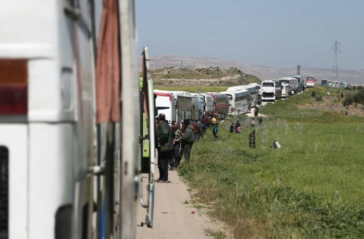 Photo d'un convoi transporant combattants rebelles et civils hors de la Ghouta orientale, près de Damas, le 26 mars 2018