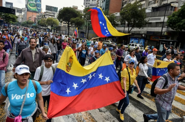 Des militants de l'opposition participent à une marche, le 23 janvier 2019 à Caracas, au Venezuela