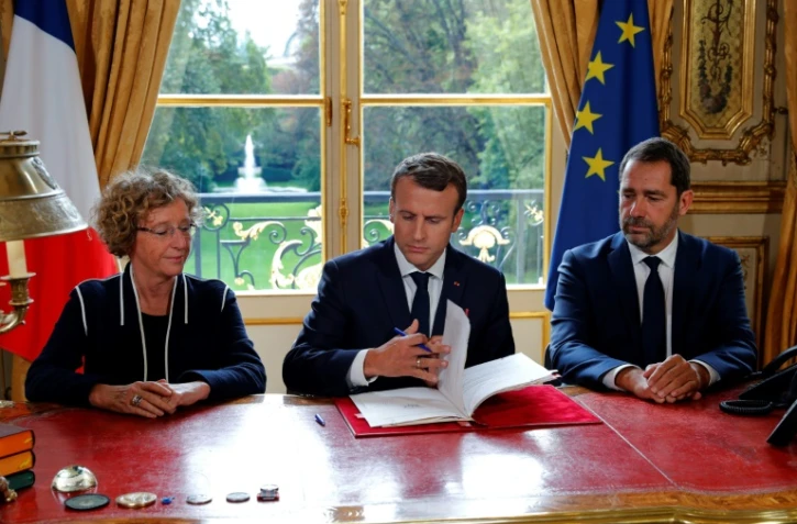 Emmanuel Macron, aux côtés de Muriel Penicaud et Christophe Castaner signe les ordonnances réformant le droit du travail, le 22 septembre 2017 à l'Elysée