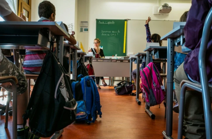 Des enfant d'une école primaire de Lyon font leur rentrée scolaire le 2 septembre 2014.