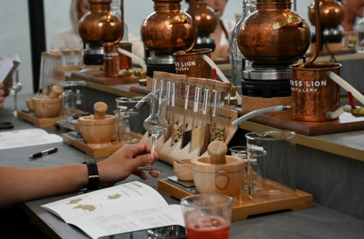 In a Singapore distillery, the smell of pine, citrus and flowers fills the air as students crush juniper berries, blending them with their own choice of ingredients to make custom gin with an Asian twist