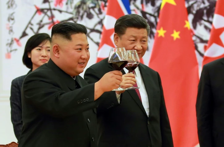 Le leader nord-coréen Kim Jong Un et le président chinois Xi Jinping (d) portent un toast, au Palais du Peuple, le 19 juin 2018 à Pékin