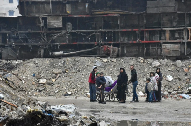 Des syriens quittent le quartier Bustan al-Qasr d'Alep, le 13 décembre 2016
