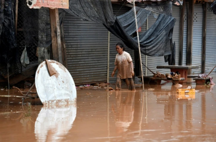 Des habitants retournent chez eux après les inondations provoquées par l'effondrement d'un barrage, le 26 juillet 2018 à Sanamxai, dans la province d'Attapeu, au Laos